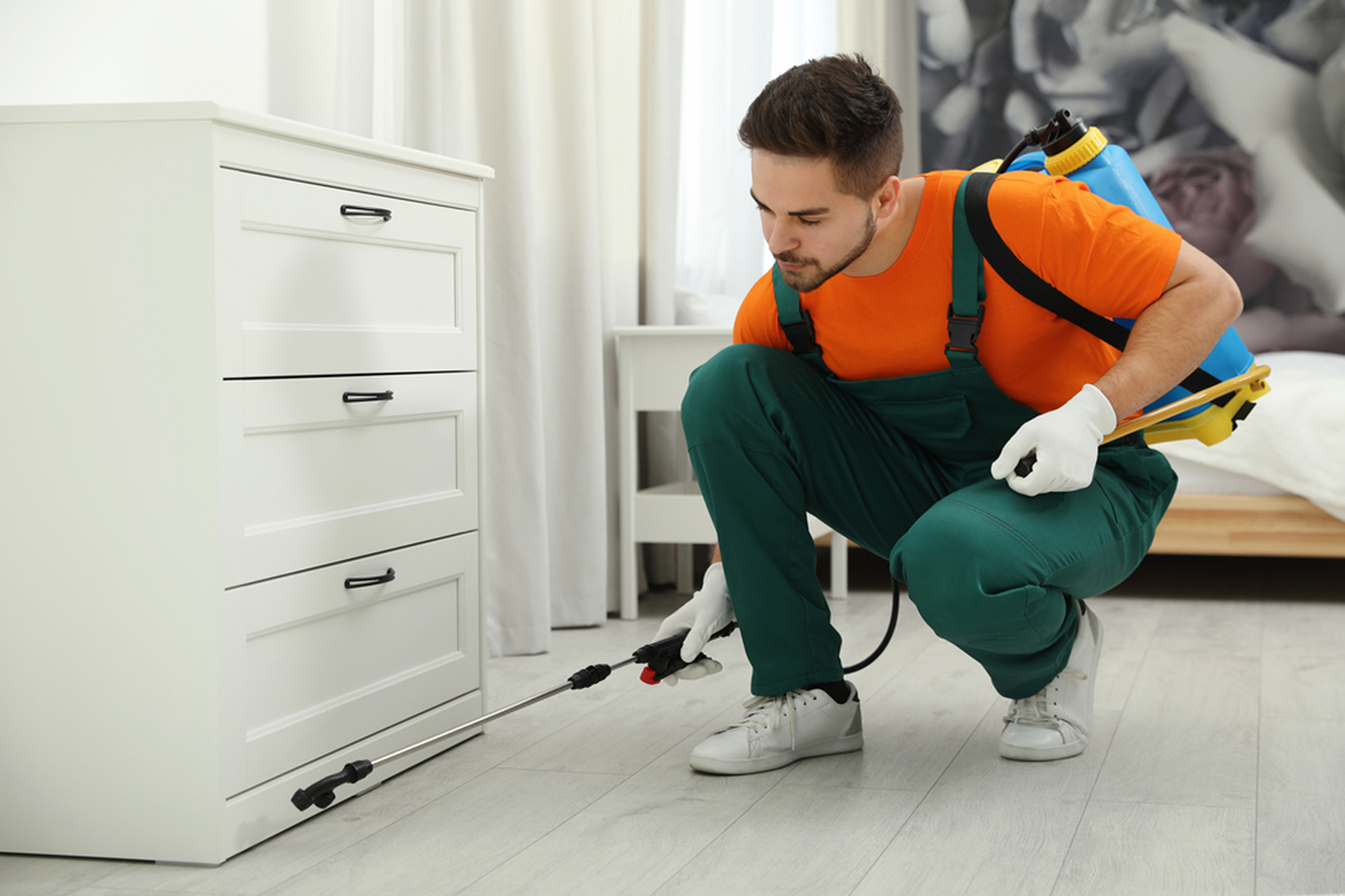Experienced pest control specialist performing roach removal service in a Naperville IL residence